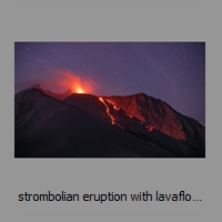 strombolian eruption with lavaflow at night